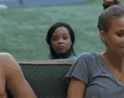 A Group Of People Are Sitting On A Couch And One Woman Is Looking At The Camera . GIF