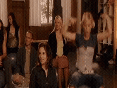 A Group Of People Are Sitting On A Couch In A Living Room . GIF