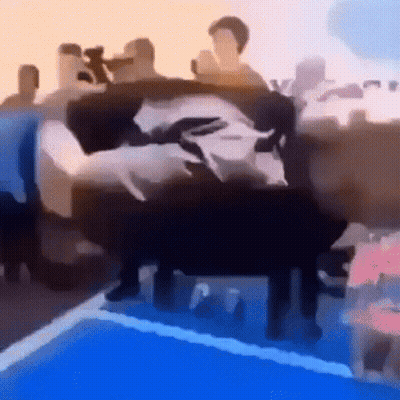 A Group Of People Are Sitting On A Couch In Front Of A Swimming Pool . GIF