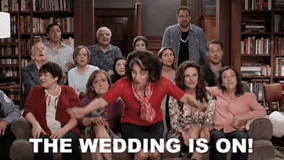 A Group Of People Are Sitting On A Couch With The Words The Wedding Is On GIF