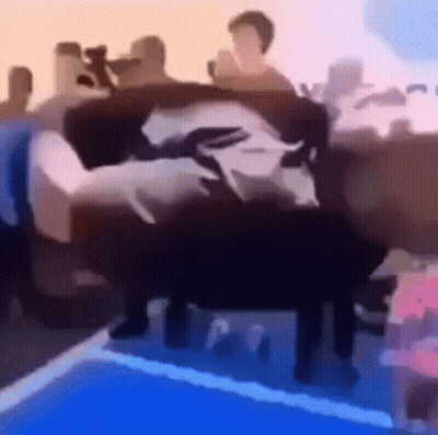 A Group Of People Are Sitting On A Couch . GIF