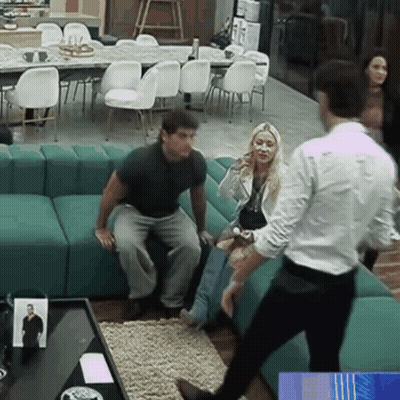 A Group Of People Are Sitting On A Green Couch GIF