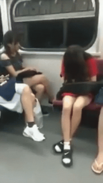 A Group Of People Are Sitting On A Subway Train GIF