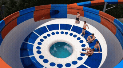 A Group Of People Are Sitting On Top Of A Water Slide That Looks Like An Eye GIF