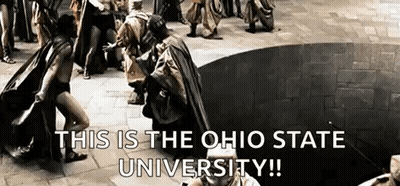 A Group Of People Are Standing Around A Circle With The Words This Is The Ohio State University Written On The Bottom . GIF
