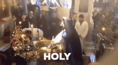 A Group Of People Are Standing Around A Coffin In A Church With The Word Holy Written On The Bottom . GIF
