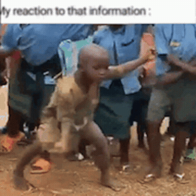 A Group Of People Are Standing Around A Little Boy Who Is Dancing . GIF