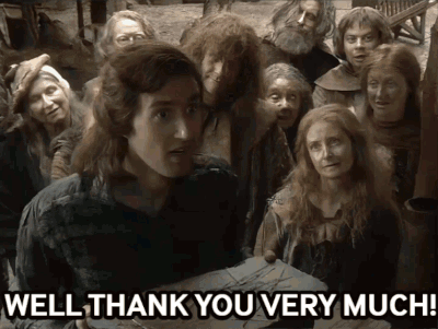 A Group Of People Are Standing Around A Man Who Says Well Thank You Very Much .. GIF