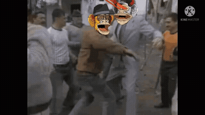 A Group Of People Are Standing Around A Man With A Monkey On His Head GIF