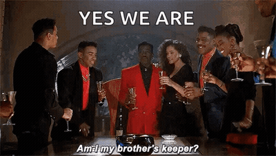 A Group Of People Are Standing Around A Table Holding Champagne Glasses And A Man In A Red Suit Is Saying Yes We Are . GIF
