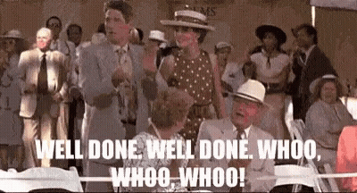 A Group Of People Are Standing Around A Table With The Words Well Done Well Done Whoo Whoo Whoo Written On Them . GIF
