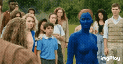 A Group Of People Are Standing Around A Woman In A Blue Bodysuit . GIF