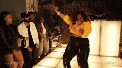 A Group Of People Are Standing Around A Woman On A Dance Floor With Creeping Written On The Bottom GIF