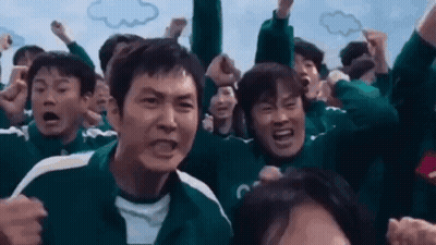 A Group Of People Are Standing In A Crowd With Their Arms In The Air And Making Funny Faces . GIF