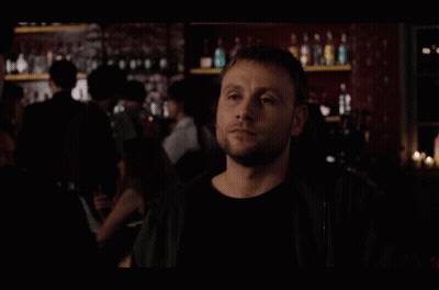 A Group Of People Are Standing In A Dark Room With A Man Looking Up GIF