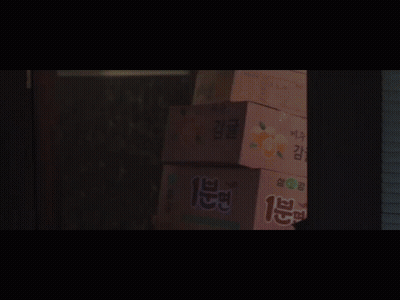 A Group Of People Are Standing In A Dark Room With A Sign That Says ' I 'M Sorry ' On It GIF