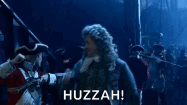 A Group Of People Are Standing In A Dark Room With The Word Huzzah Written On The Bottom . GIF