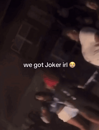 A Group Of People Are Standing In A Dark Room With The Words We Got Joker Irl On The Bottom GIF
