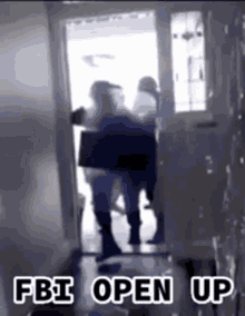 A Group Of People Are Standing In A Doorway With The Words `` Fbi Open Up '' Written On The Bottom . GIF