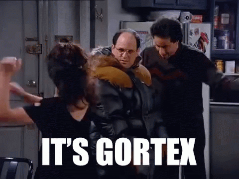 A Group Of People Are Standing In A Kitchen With The Words `` It 'S Cortex '' On The Screen . GIF