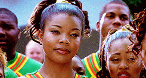 A Group Of People Are Standing In A Line And One Of Them Is Wearing A Ponytail . GIF