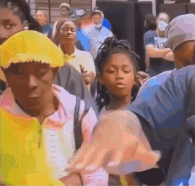 A Group Of People Are Standing In A Line Including A Girl Wearing A Yellow Hat GIF