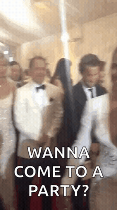 A Group Of People Are Standing In A Room And One Of Them Is Holding A Sword . GIF