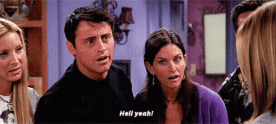 A Group Of People Are Standing In A Room And One Of Them Is Saying " Hell Yeah " GIF