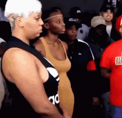 A Group Of People Are Standing In A Room And One Of Them Is Wearing A Red Shirt That Says Raf GIF