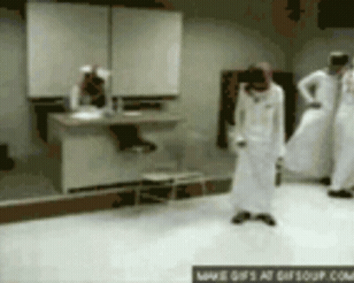 A Group Of People Are Standing In A Room With A Sign That Says ' Www.gifsoup.com ' On The Bottom GIF