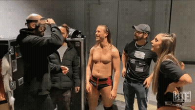 A Group Of People Are Standing In A Room With The Letters Bte On The Bottom Left GIF