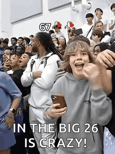 A Group Of People Are Standing In A Room With The Words In The Big 26 Is Crazy Written On The Bottom GIF