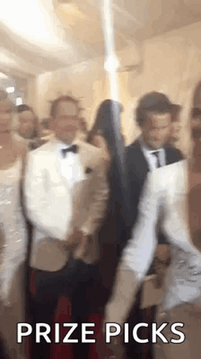 A Group Of People Are Standing In A Room With The Words `` Prize Picks '' Written On It . GIF