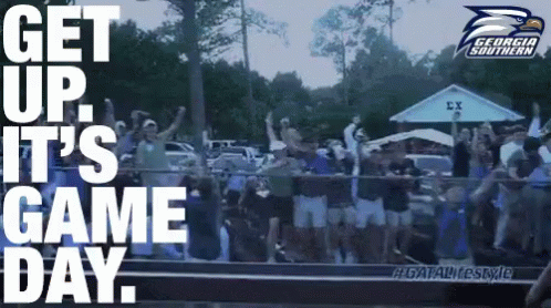 A Group Of People Are Standing In Front Of A Banner That Says Get Up It 'S Game Day GIF