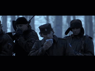 A Group Of People Are Standing In Front Of A Bus That Says ' Ambulance ' On The Side Of It GIF