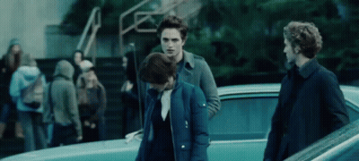 A Group Of People Are Standing In Front Of A Car . GIF