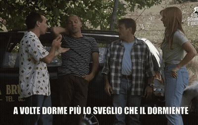 A Group Of People Are Standing In Front Of A Car That Says Brio GIF