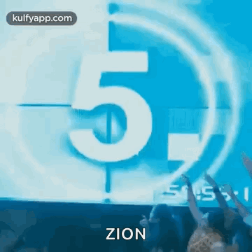 A Group Of People Are Standing In Front Of A Countdown Clock With The Number 5 On It . GIF