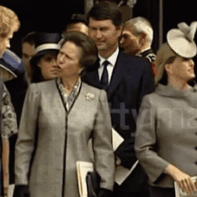 A Group Of People Are Standing In Front Of A Sign That Says ' Ttymma ' GIF