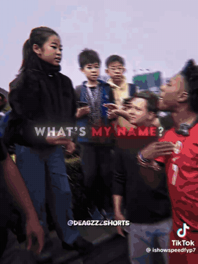 A Group Of People Are Standing In Front Of A Sign That Says What 'S My Name On It GIF
