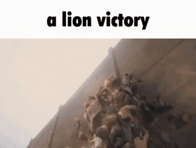 A Group Of People Are Standing In Front Of A Wall With The Words `` A Lion Victory '' Written On It . GIF