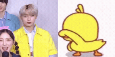 a group of people are standing next to each other and a cartoon duck is standing next to them .