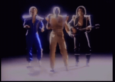A Group Of People Are Standing Next To Each Other And One Of Them Is Holding A Guitar . GIF