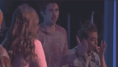 A Group Of People Are Standing Next To Each Other And One Of Them Is Saying You 'Re Either In The Smoke Club GIF