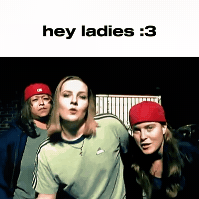 A Group Of People Are Standing Next To Each Other And One Of Them Is Wearing A Red Hat And A Green Shirt . GIF
