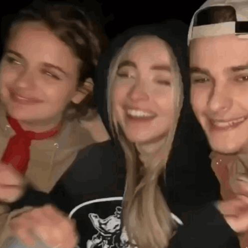 A Group Of People Are Standing Next To Each Other And Smiling For The Camera . GIF