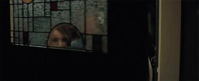 A Group Of People Are Standing Next To Each Other In A Dark Room And Smiling . GIF