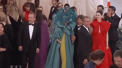 A Group Of People Are Standing Next To Each Other In A Room At A Party . GIF