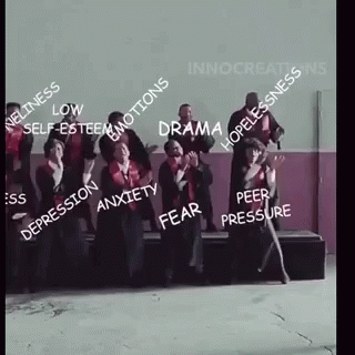 A Group Of People Are Standing Next To Each Other In A Room With A Lot Of Words On Them . GIF