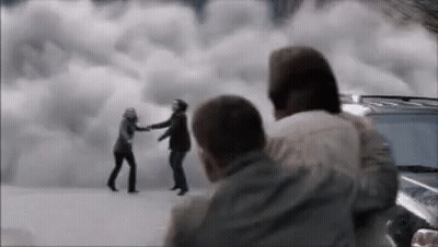A Group Of People Are Standing Next To Each Other In Front Of A Cloudy Sky . GIF